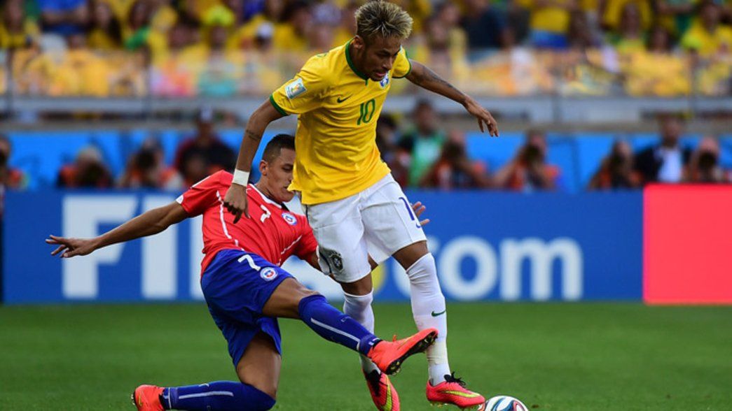 Alexis tackles Neymar at the 2014 World Cup