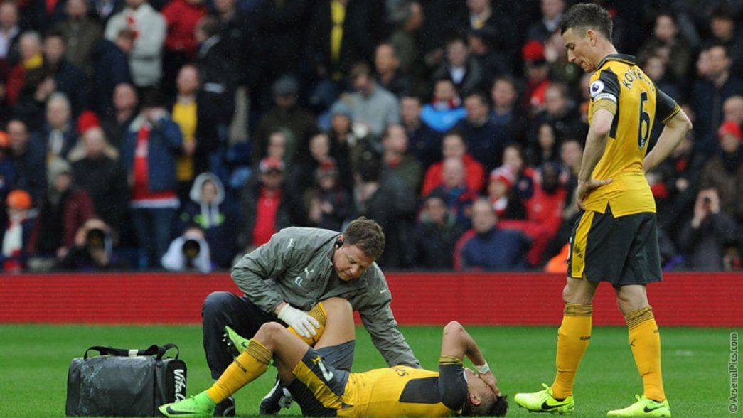 Alexis is treated after injuring his ankle against West Brom