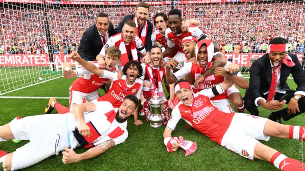 The team celebrate after winning the Emirates FA Cup