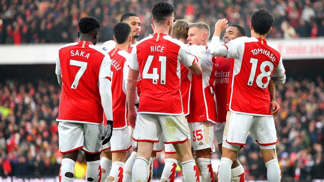 Arsenal players celebrating Martin Odegaard's goal against Wolves
