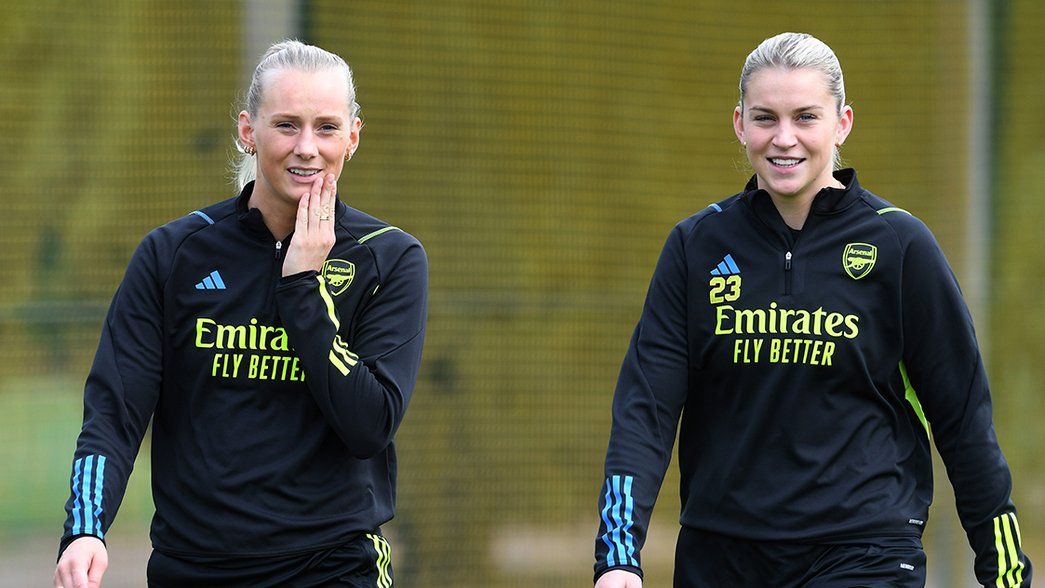 Stina Blackstenius and Alessia Russo smile on the way to training