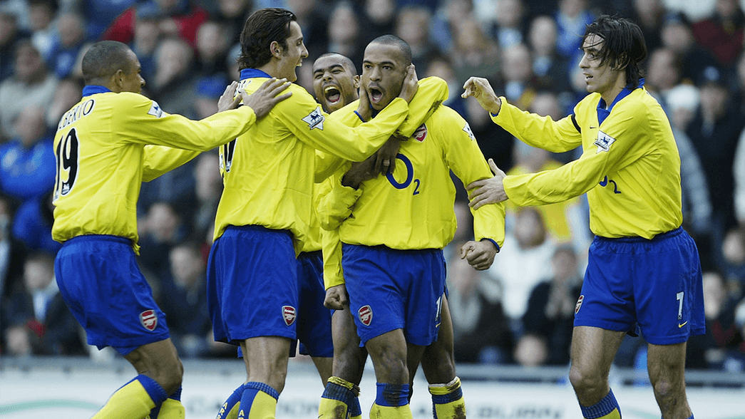 Thierry Henry is mobbed after scoring against Blackburn Rovers