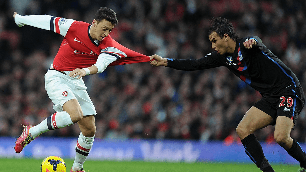 Mesut Ozil and Marouane Chamakh in action in 2014