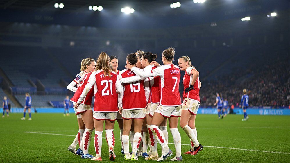 Arsenal Women huddle together in celebration after scoring against Leicester City