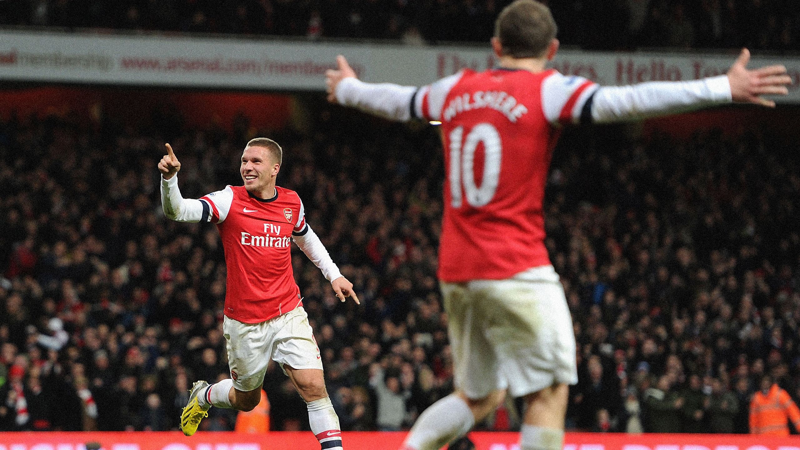 Lukas Podolski of Arsenal celebrates after scoring their third goal during the Barclays Premier League match between Arsenal and Newcastle United at Emirates Stadium on December 29, 2012