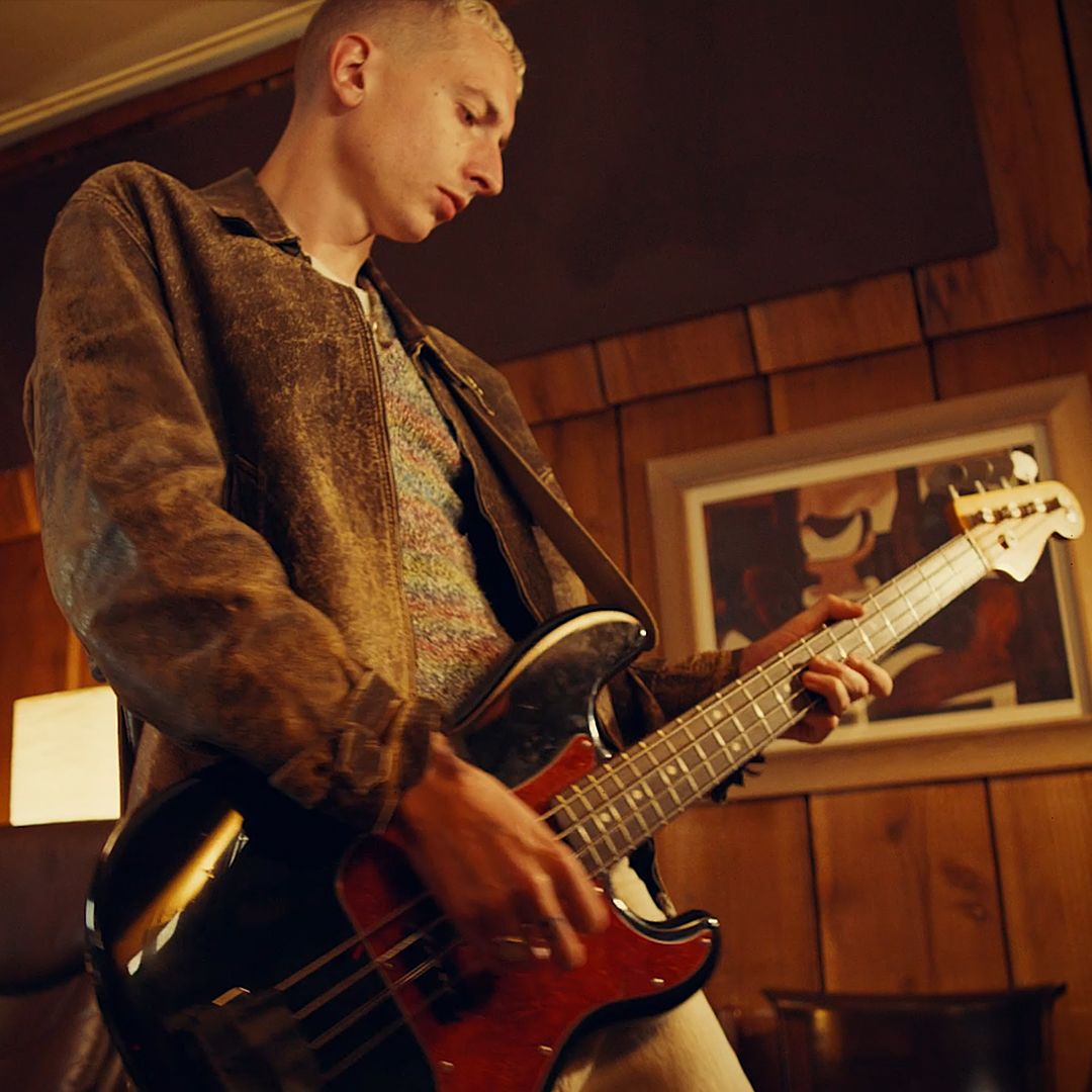 An image of Theo Ellis with a guitar