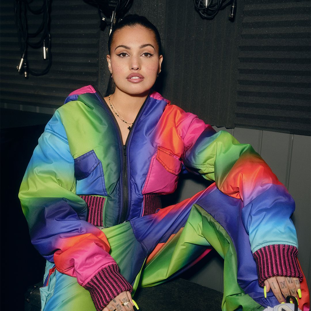 An image of Mabel in a multi-coloured tracksuit