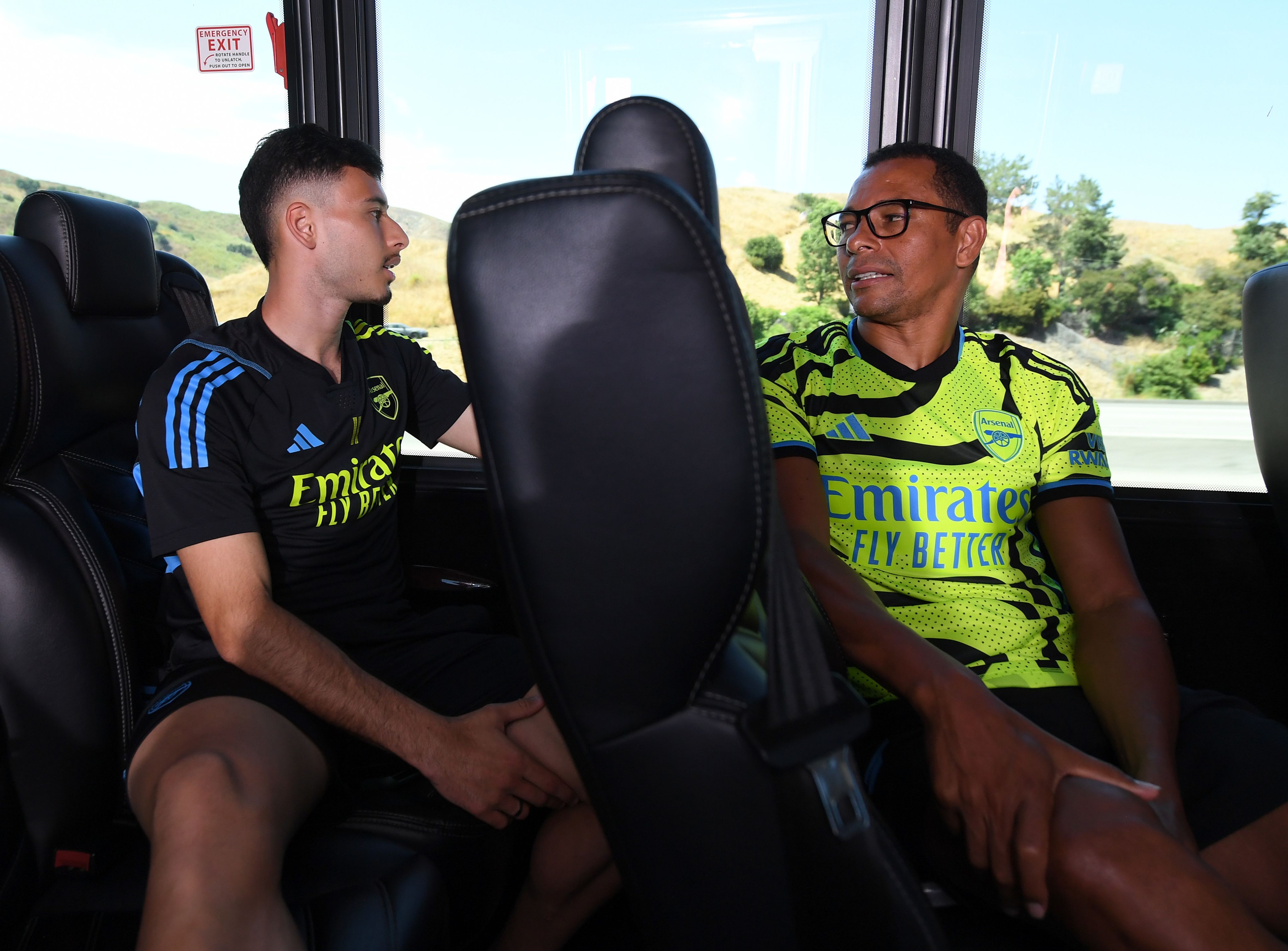 Gilberto speaks to Gabriel Martinelli in the team bus