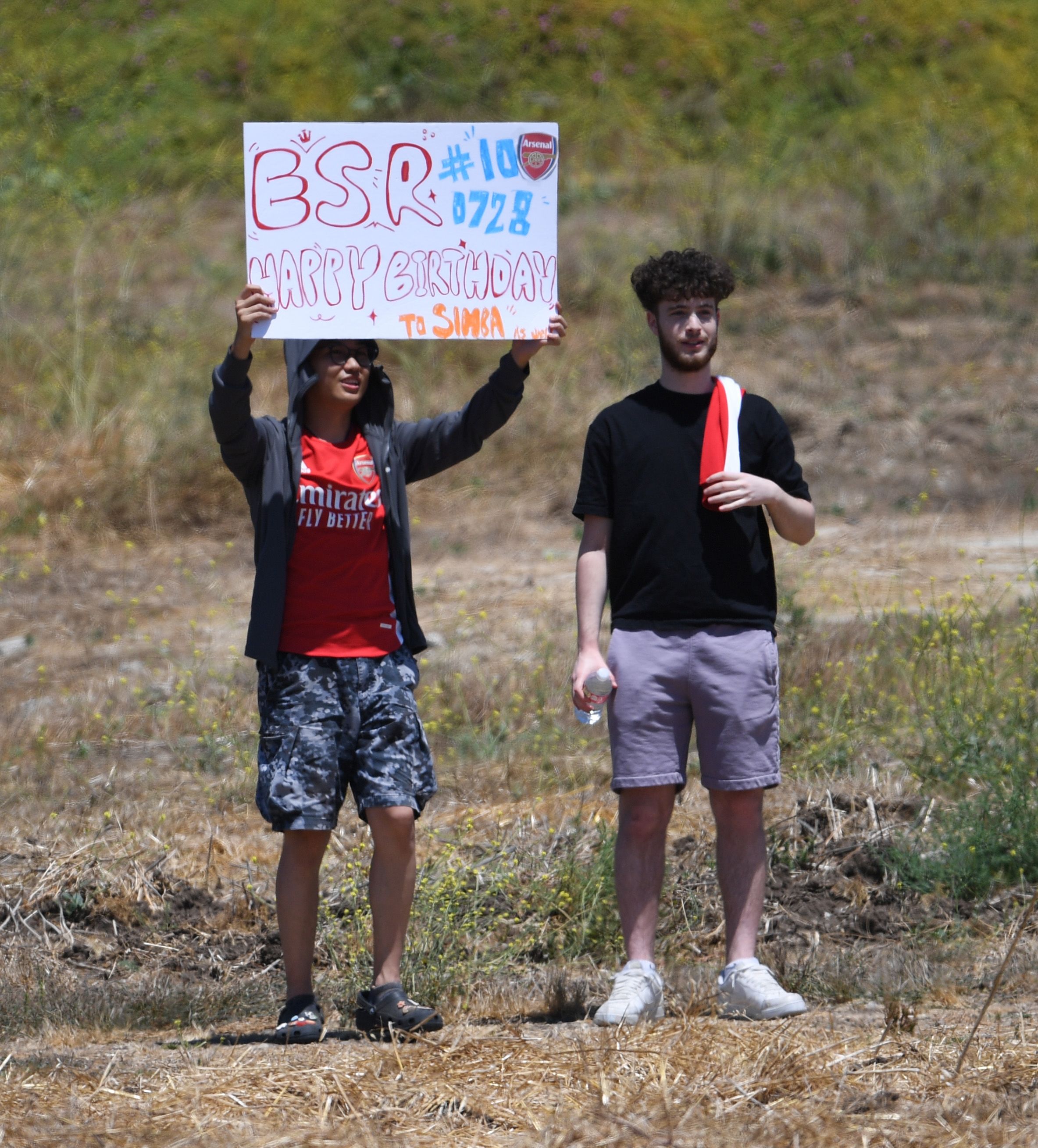 Supporters with a sign for Emile Smith Rowe at training