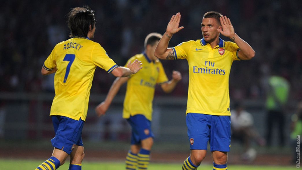 Lukas Podolski celebrates scoring on the Asia tour