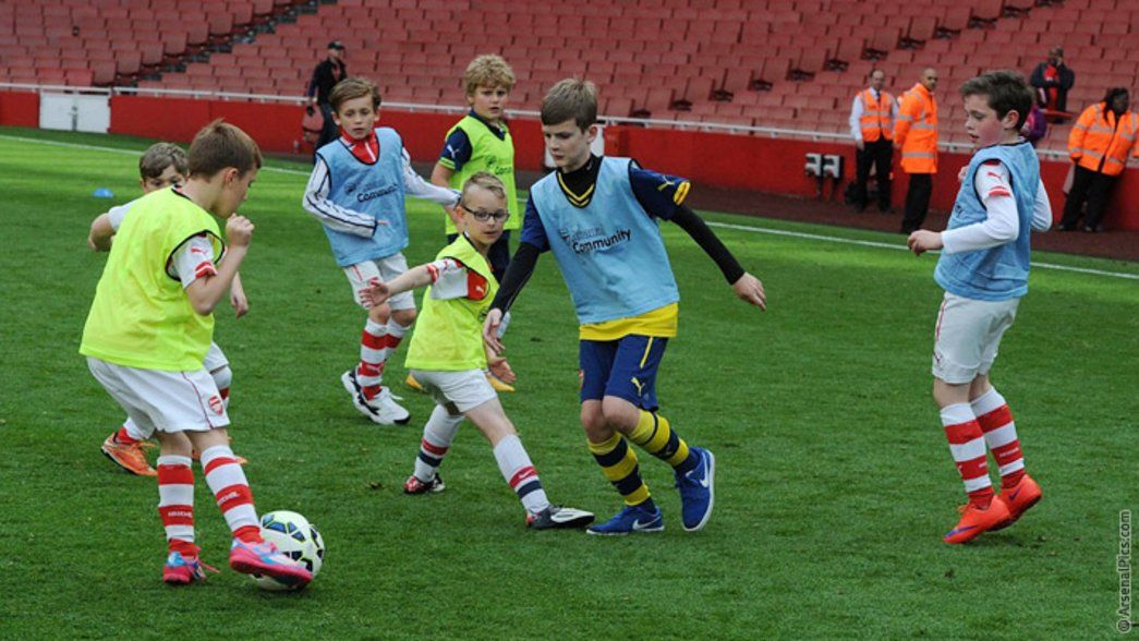 Junior Gunners play on the pitch