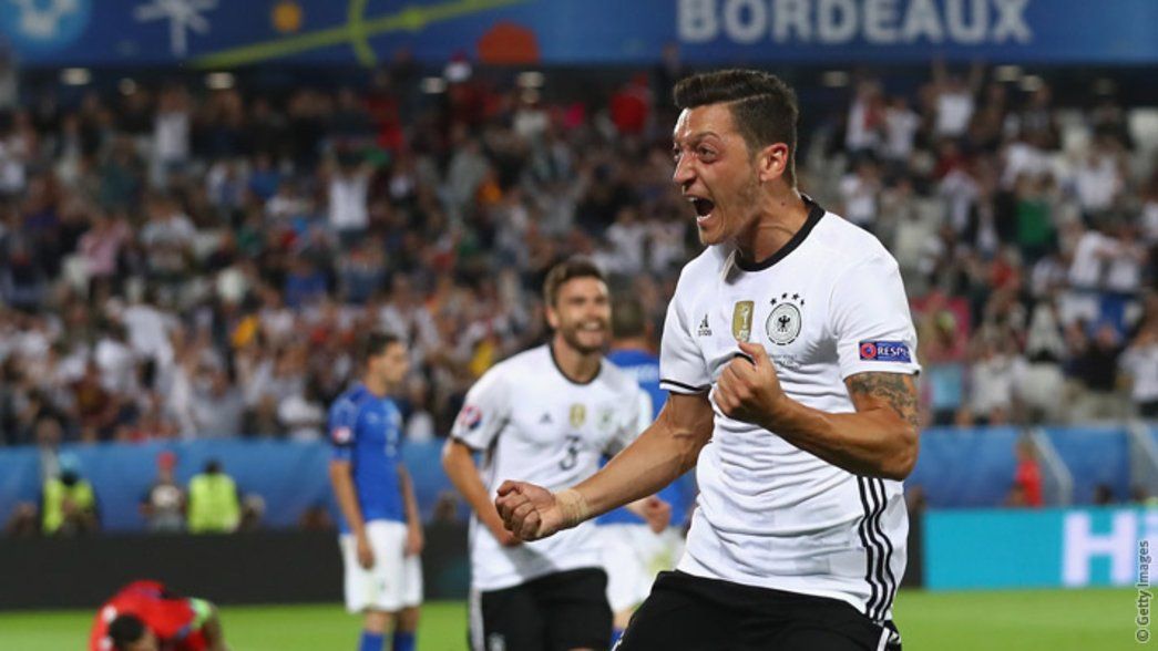 Mesut Ozil celebrates his goal against Italy
