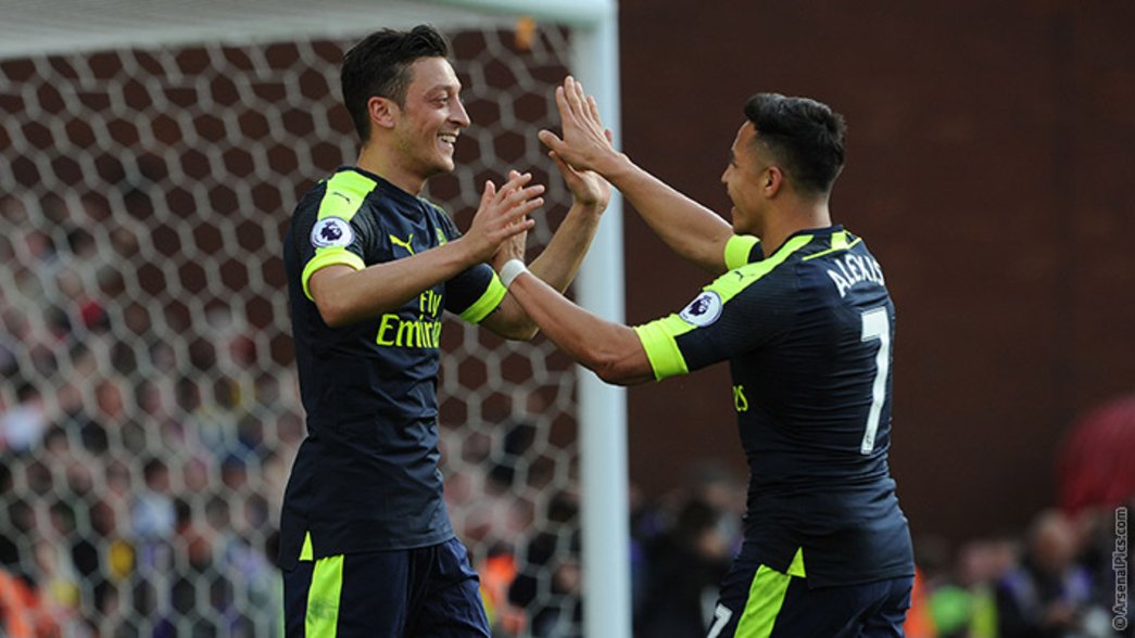 Mesut Ozil celebrates with Alexis at Stoke