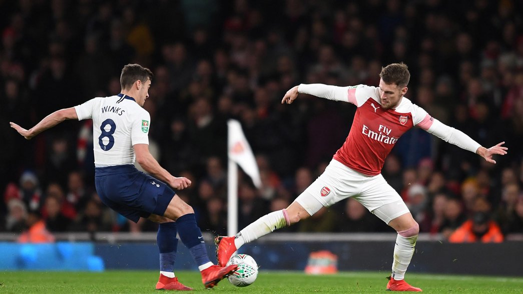 Aaron Ramsey battles for possession against Tottenham