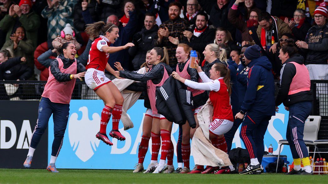 Katie McCabe celebrates with the bench after scoring the winner against Manchester City