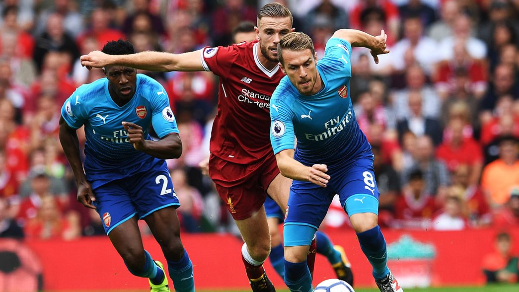 Aaron Ramsey vies for possession against Liverpool