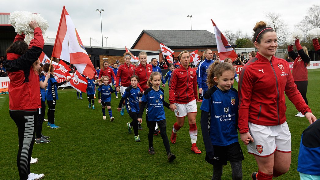 Arsenal Women walk out with mascots before playing Chelsea