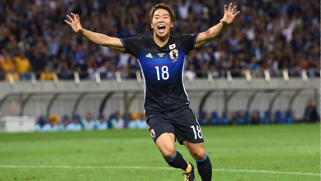 Takuma Asano celebrates scoring for Japan against Australia