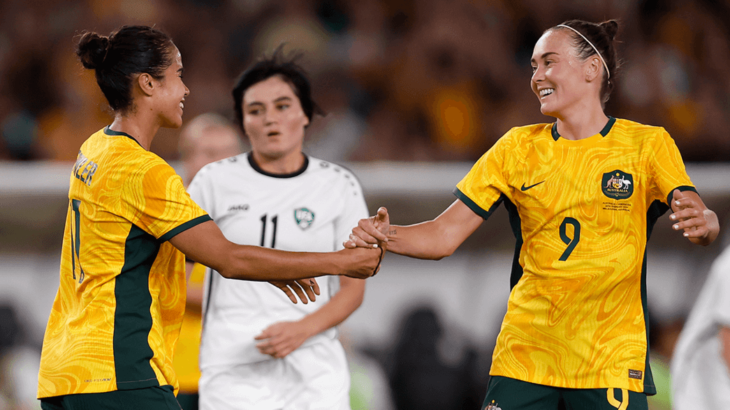 Caitlin Foord celebrates scoring against Uzbekistan with Mary Fowler