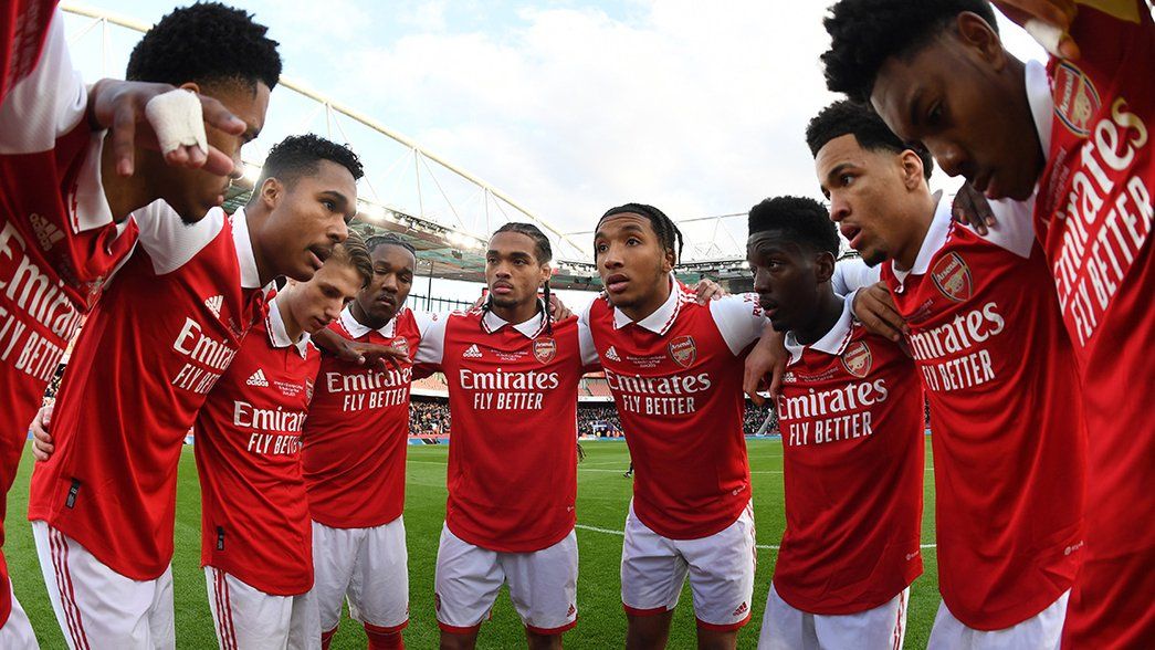 Our under-18s huddle at Emirates Stadium before kick off