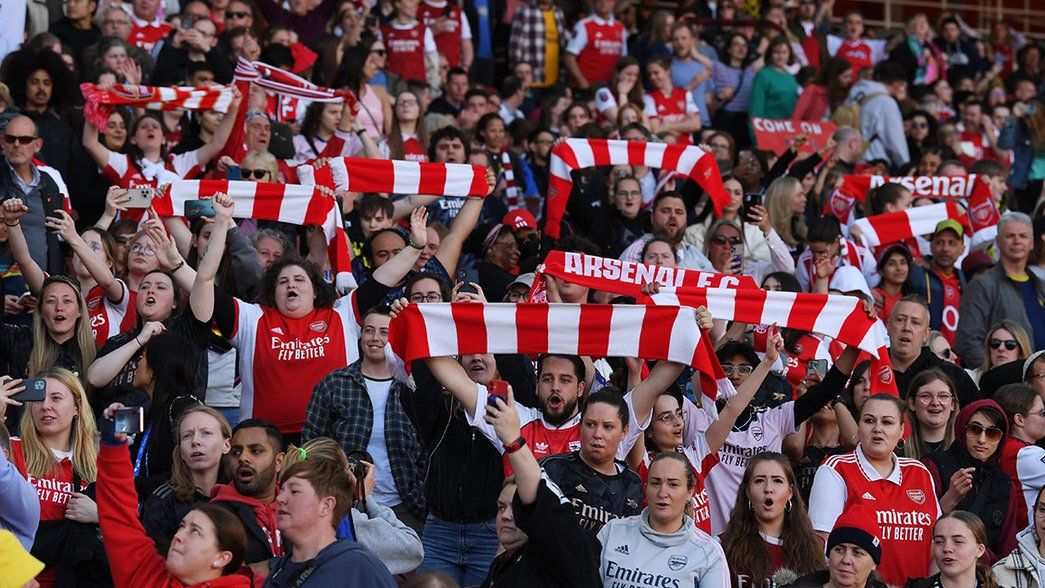 Arsenal supporters raise their flags in the stands of Emirates Stadiumq