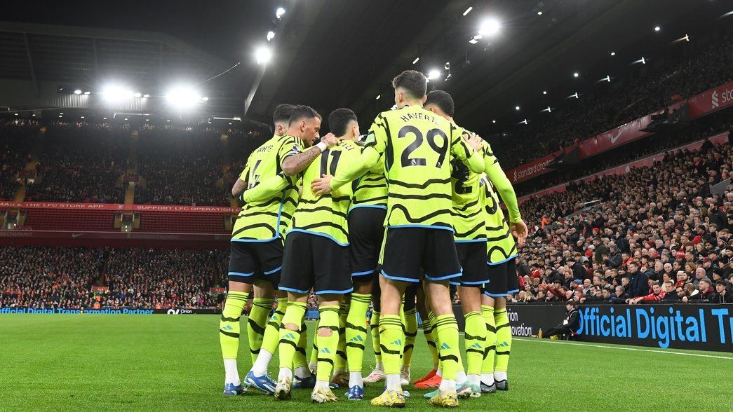 Arsenal players celebrate the opening goal against Liverpool