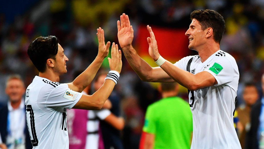 Mesut Ozil and Mario Gomez celebrate Germany's dramatic win over Sweden
