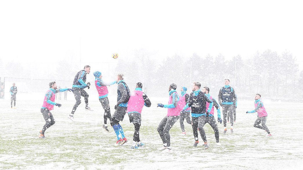 The Arsenal squad train in the snow before facing Manchester City
