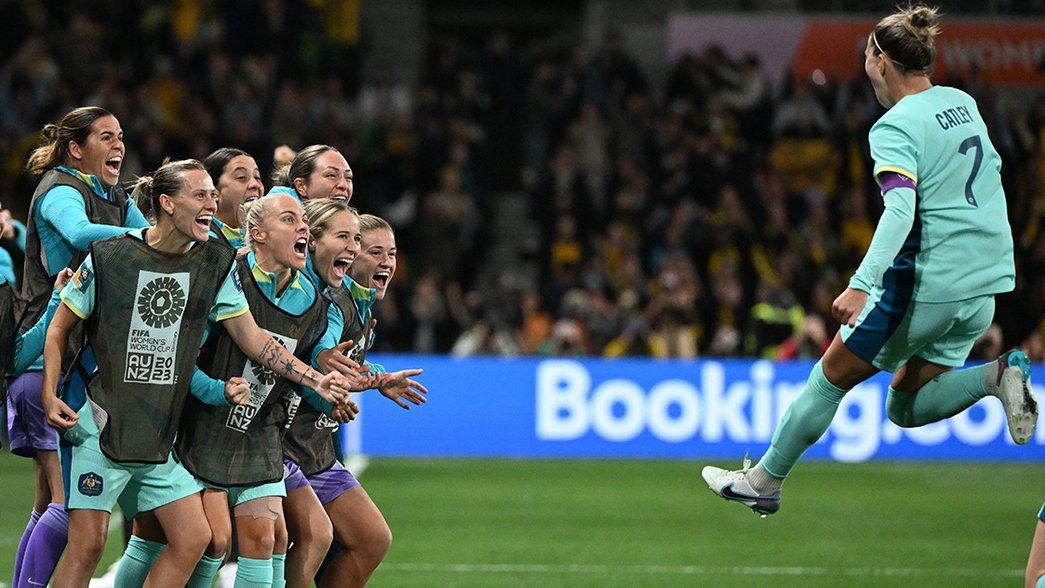 Steph Catley celebrates with the Australian bench after scoring a penalty
