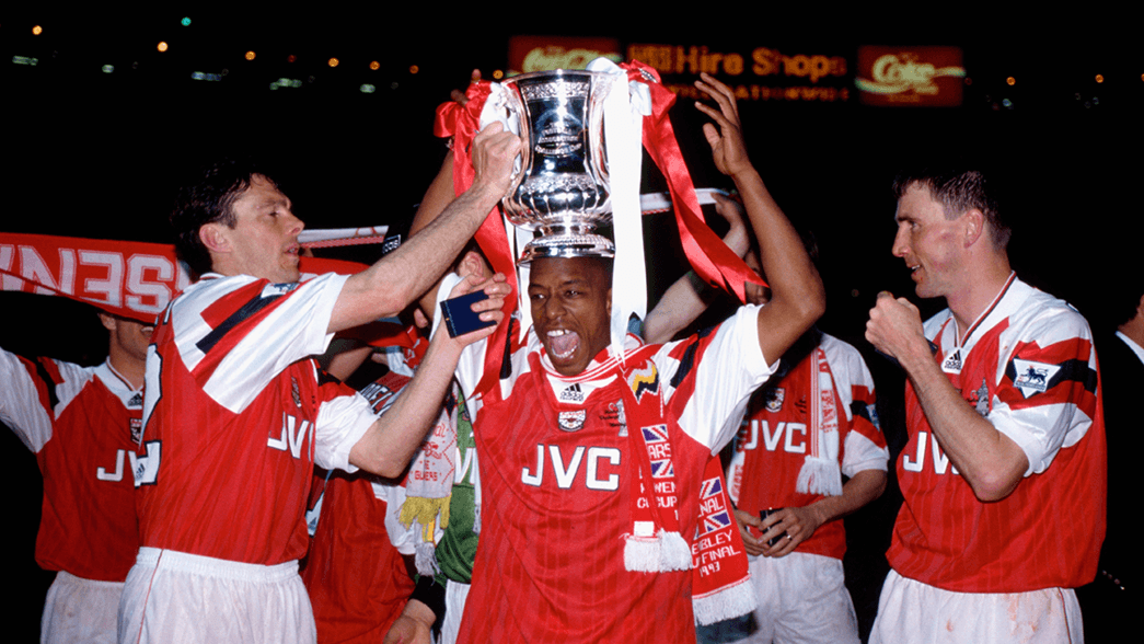 Ian Wright celebrates with the League Cup trophy in 1993