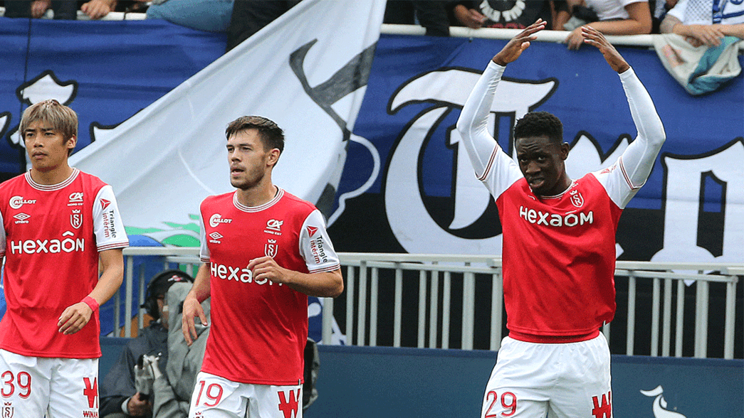 Folarin Balogun celebrates scoring for Reims