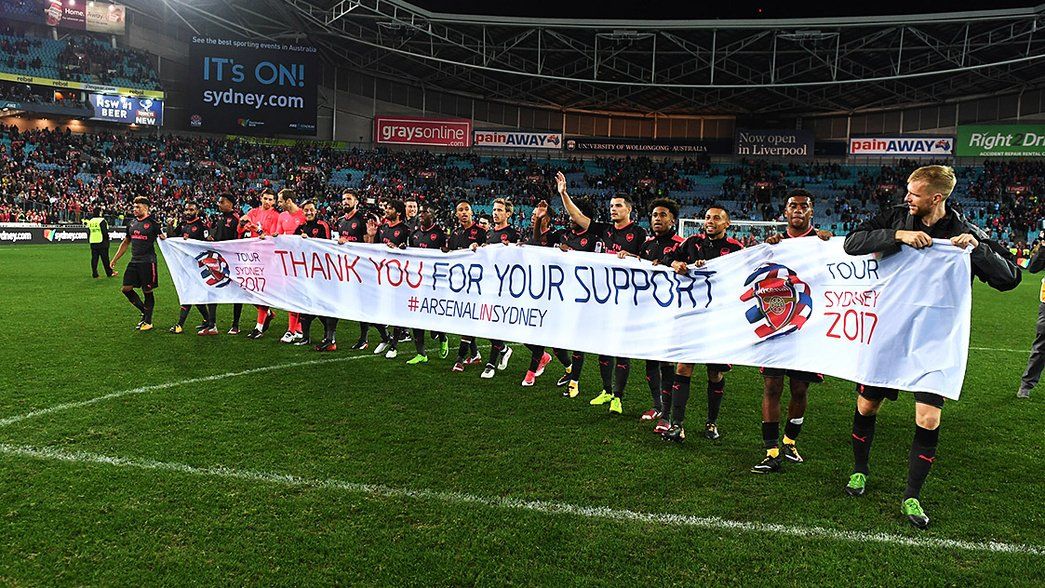 The Arsenal players display a banner at Sydney FC game
