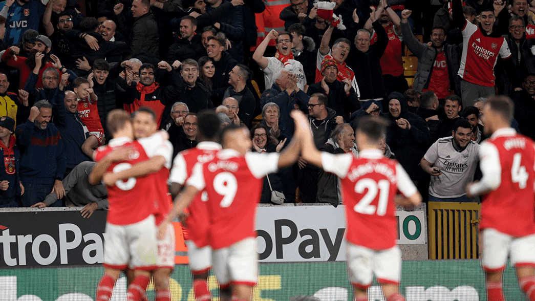 Arsenal supporters celebrate Martin Odegaard scoring at Wolves