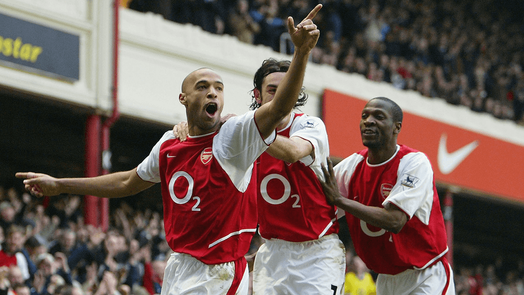 Thierry Henry celebrates scoring against Man Utd in 2004