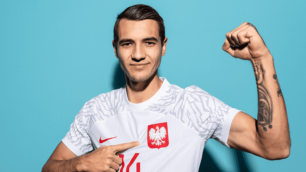 Jakub Kiwior posing in a Poland shirt ahead of the World Cup