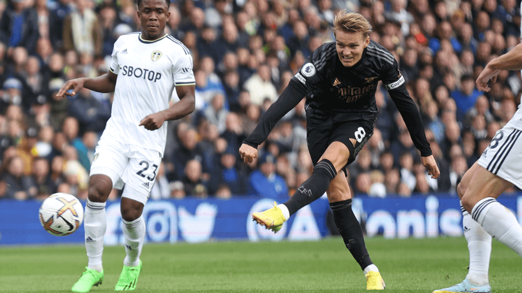 Martin Odegaard takes a shot against Leeds United