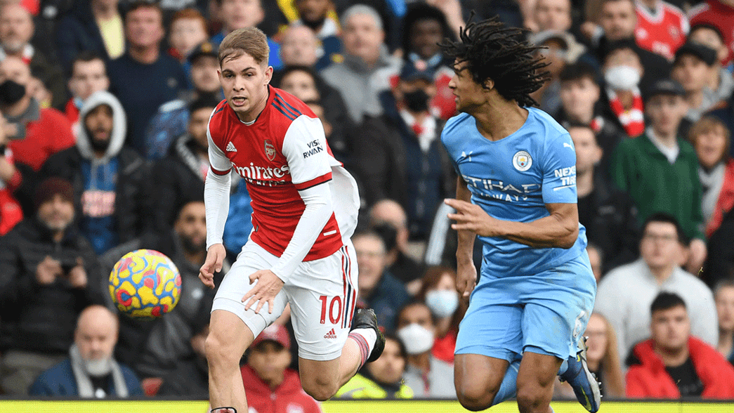 Emile Smith Rowe takes on Nathan Ake of Manchester City
