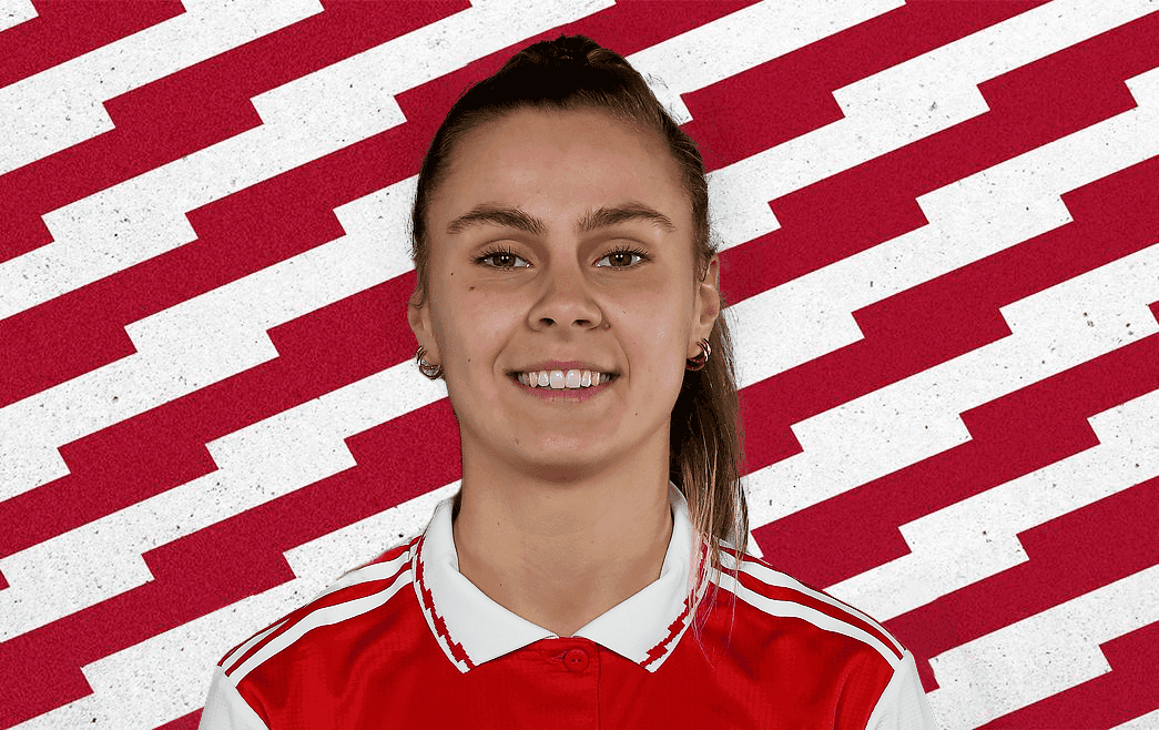 Victoria Pelova headshot in front of a red and white background